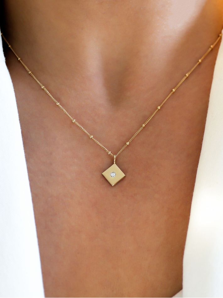 Gold diamond flush set kite pendant