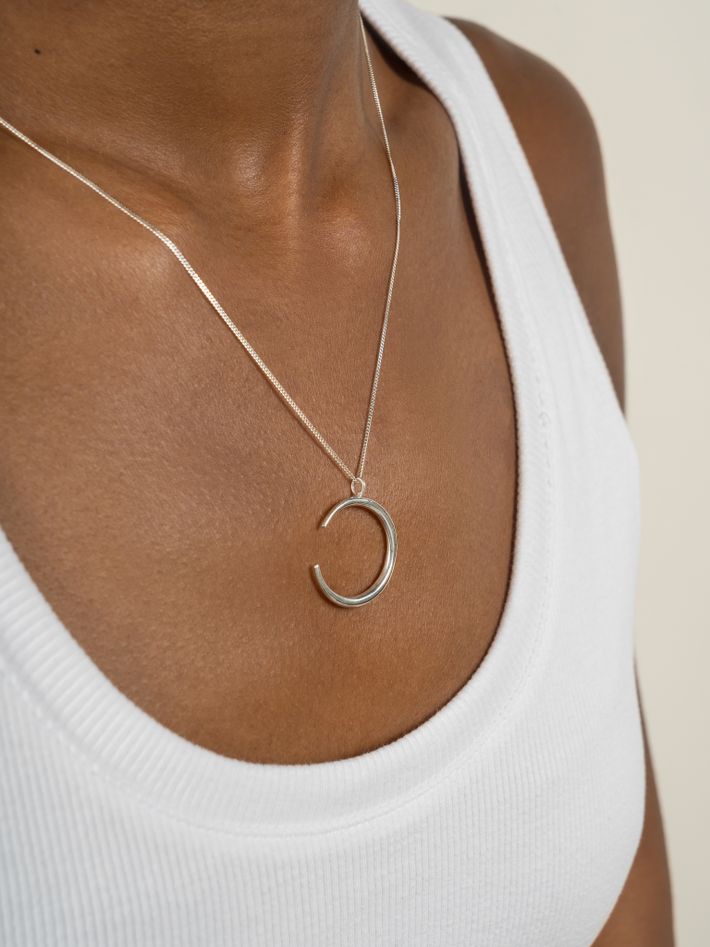 Crescent shaped pendant in sterling silver